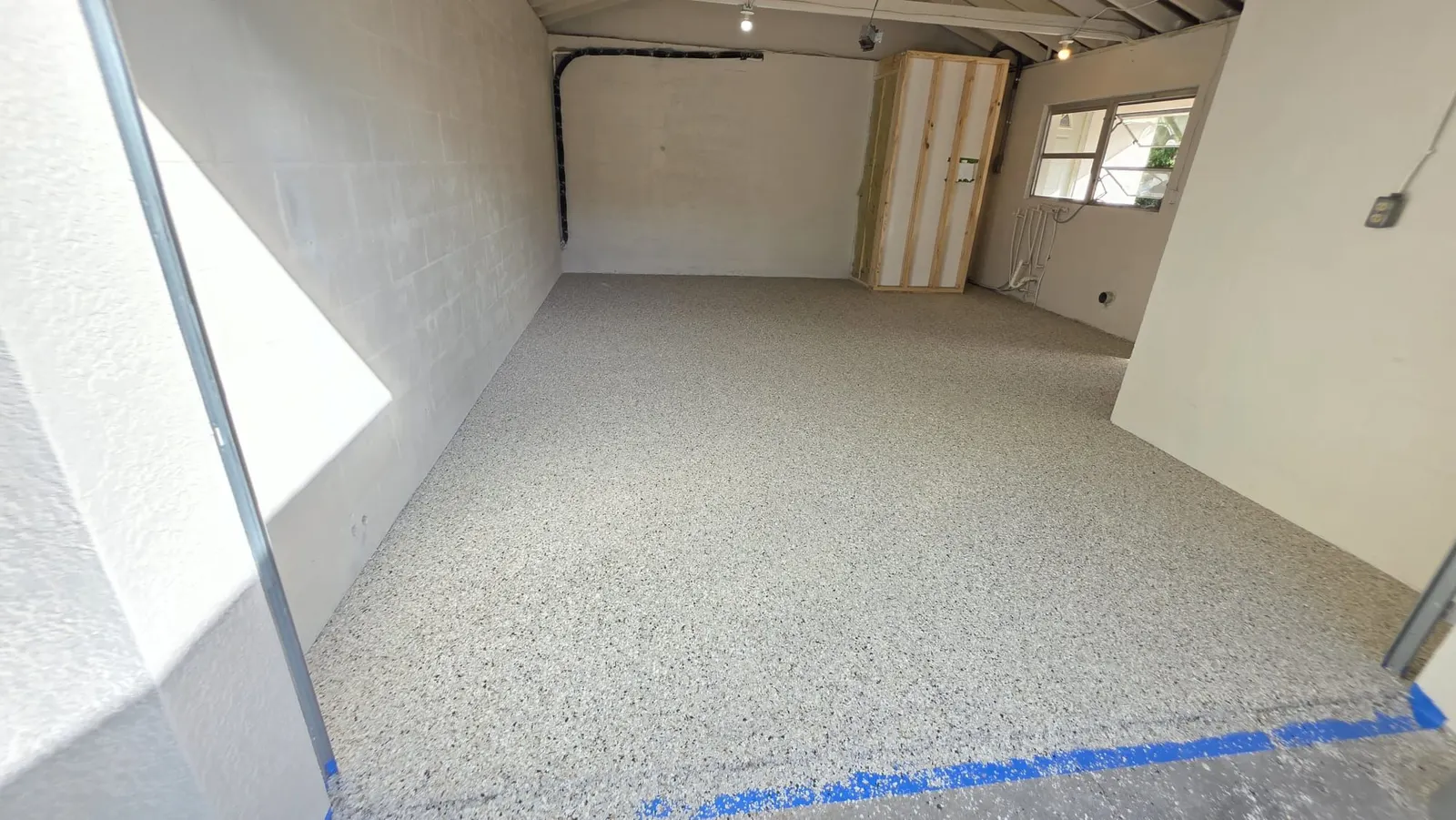 Garage floor after installing a flake epoxy system with a clear top coat